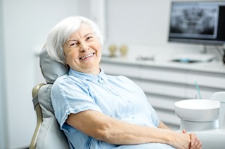 An older woman smiling in the dentist’s chair