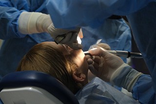 Dentist performing surgery