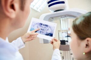 Dentist and patient reviewing dental imaging for crown creation