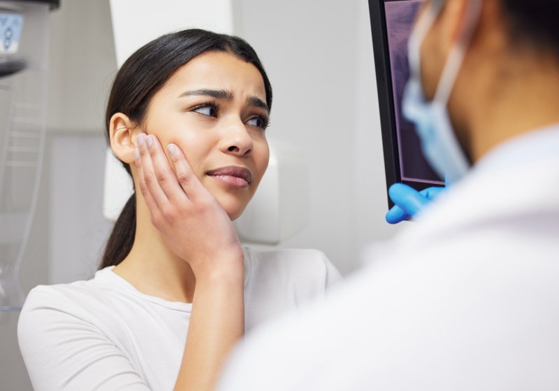 a woman with a dental emergency 